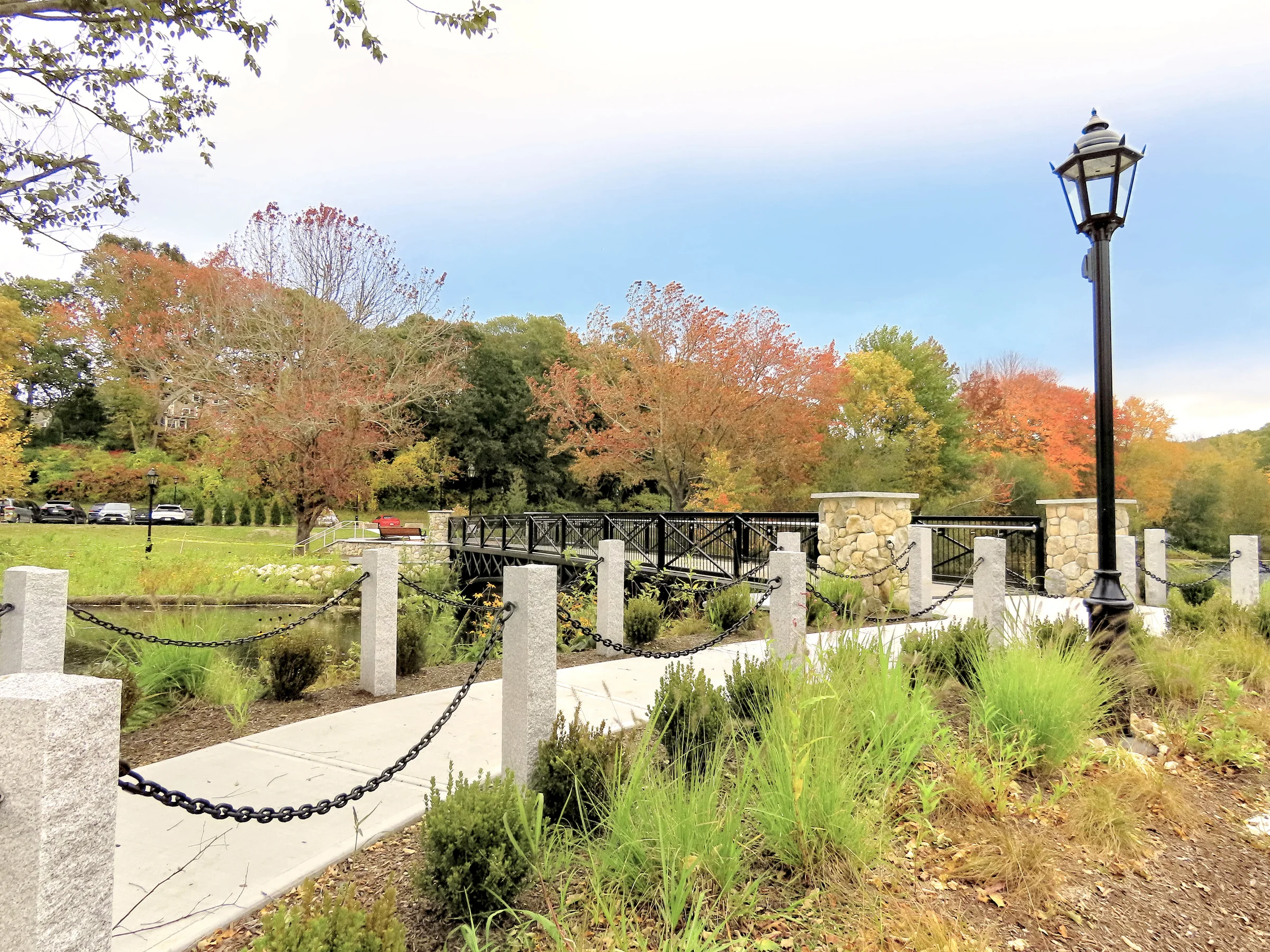 Finished waterside promenade with ornamental planting and lamp posts