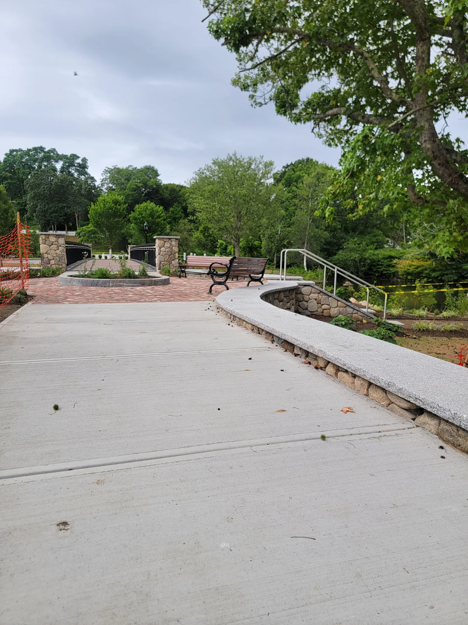 Finished concrete promenade with railings and low stone walls