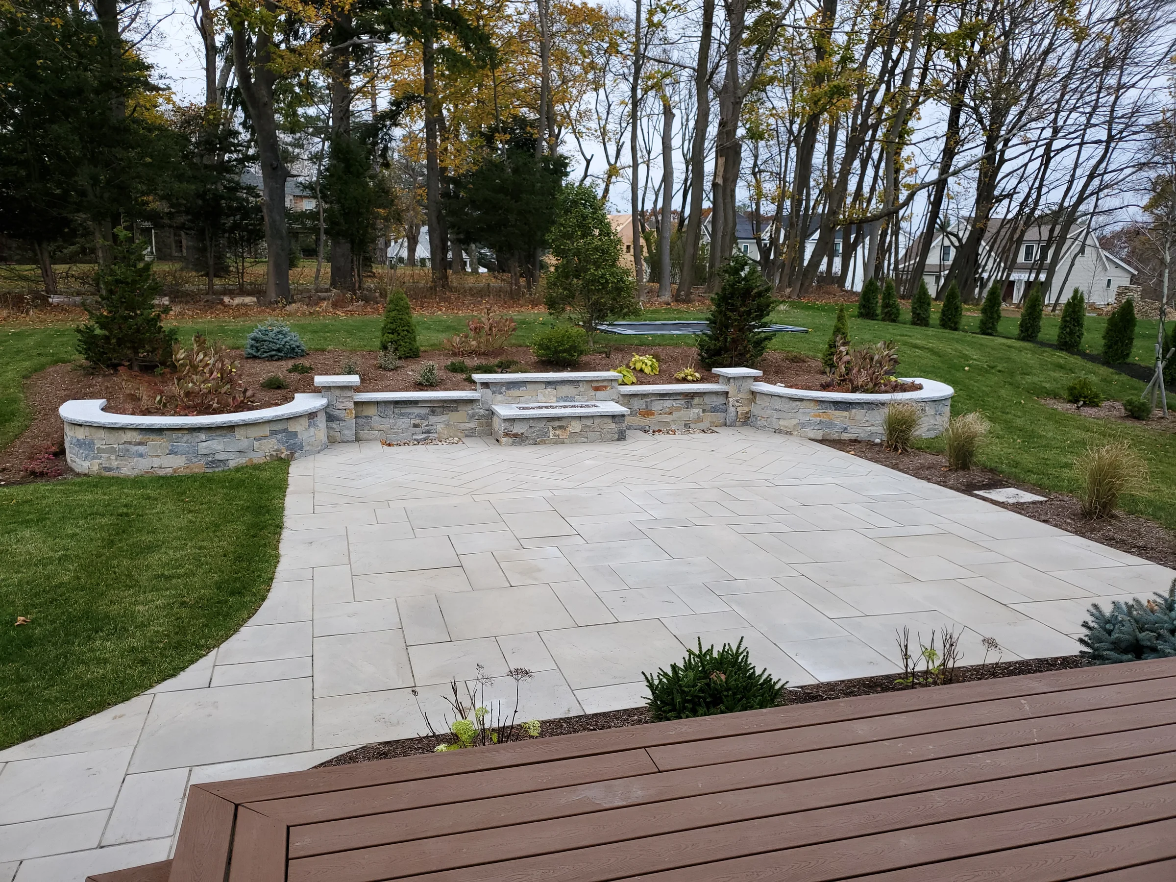 Finished backyard patio opening to a green lawn