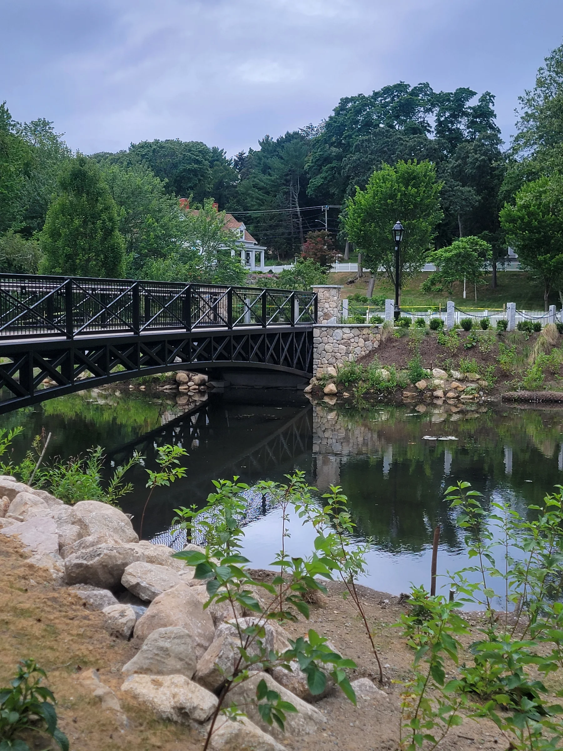 Footbridge crossing a landscaped pond